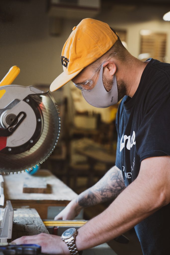 Photo of a man working with a bandsaw.