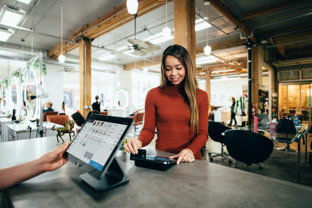 Woman paying at a cashier with a credit card