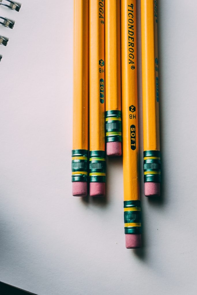 Photo of yellow number 2 pencils on a white sheet of paper.