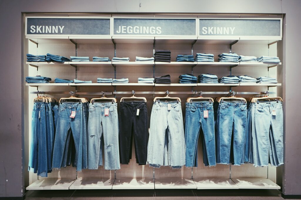 Jeans hanging on a rack in a clothing store.
