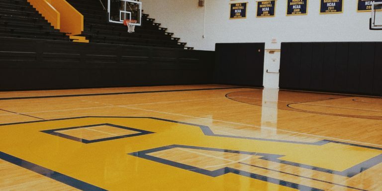 Photo of an empty high school basketball court and gym.
